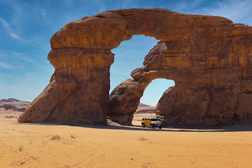 Car Driving through a Natural Arch 