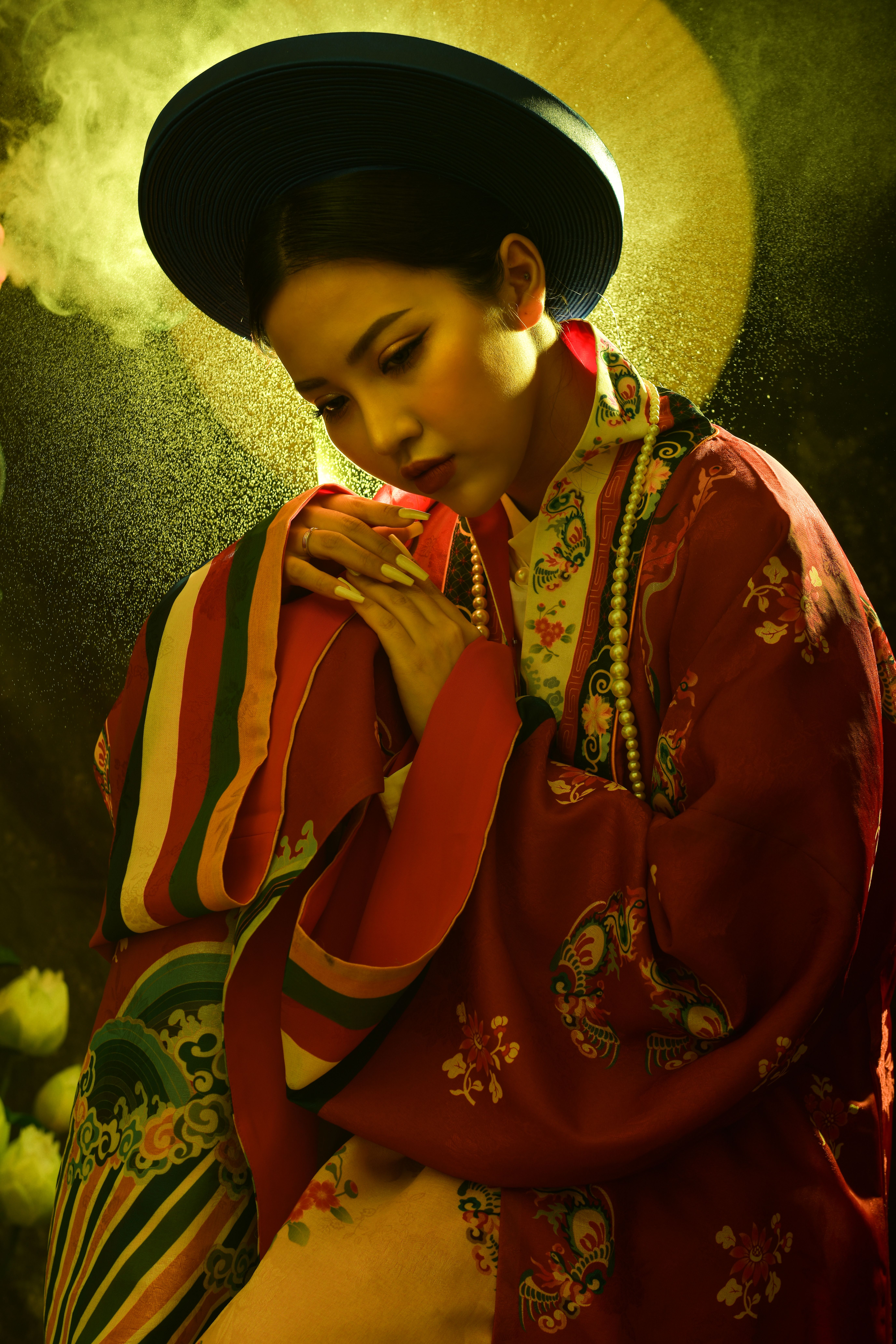 Elegant portrait of a woman in vibrant traditional clothing with artistic lighting.