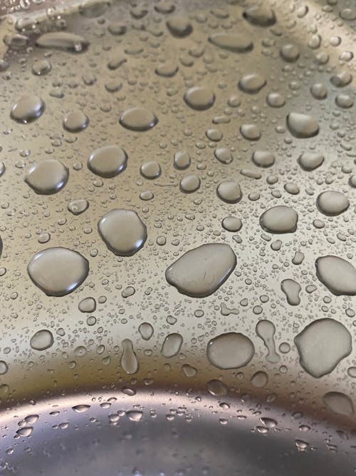 Free Close-Up Shot of Water Drops on a Metal Stock Photo