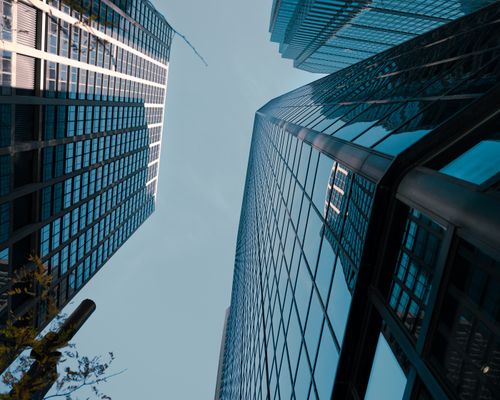 Free Urban skyscrapers in Philadelphia reflect the sky in a dramatic low-angle view. Stock Photo