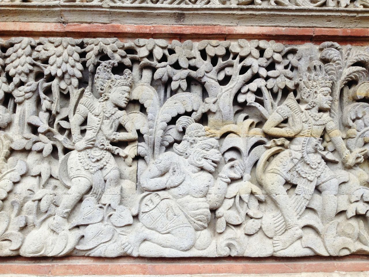detailed stone relief depicting mythological scenes and figures in a c