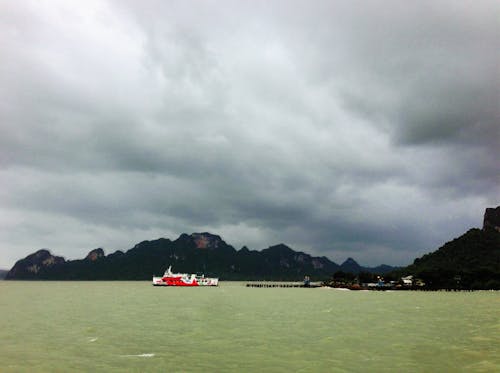 A White and Red Ferry Boat Sailing on the Sea