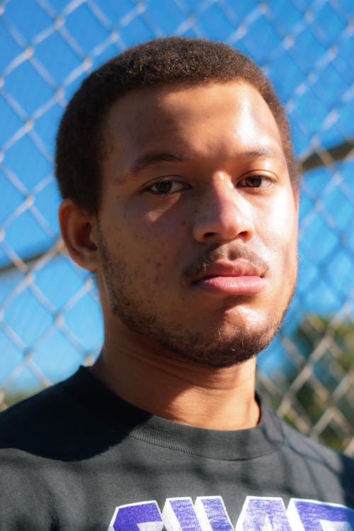 Close-Up Shot of a Man in Black Shirt