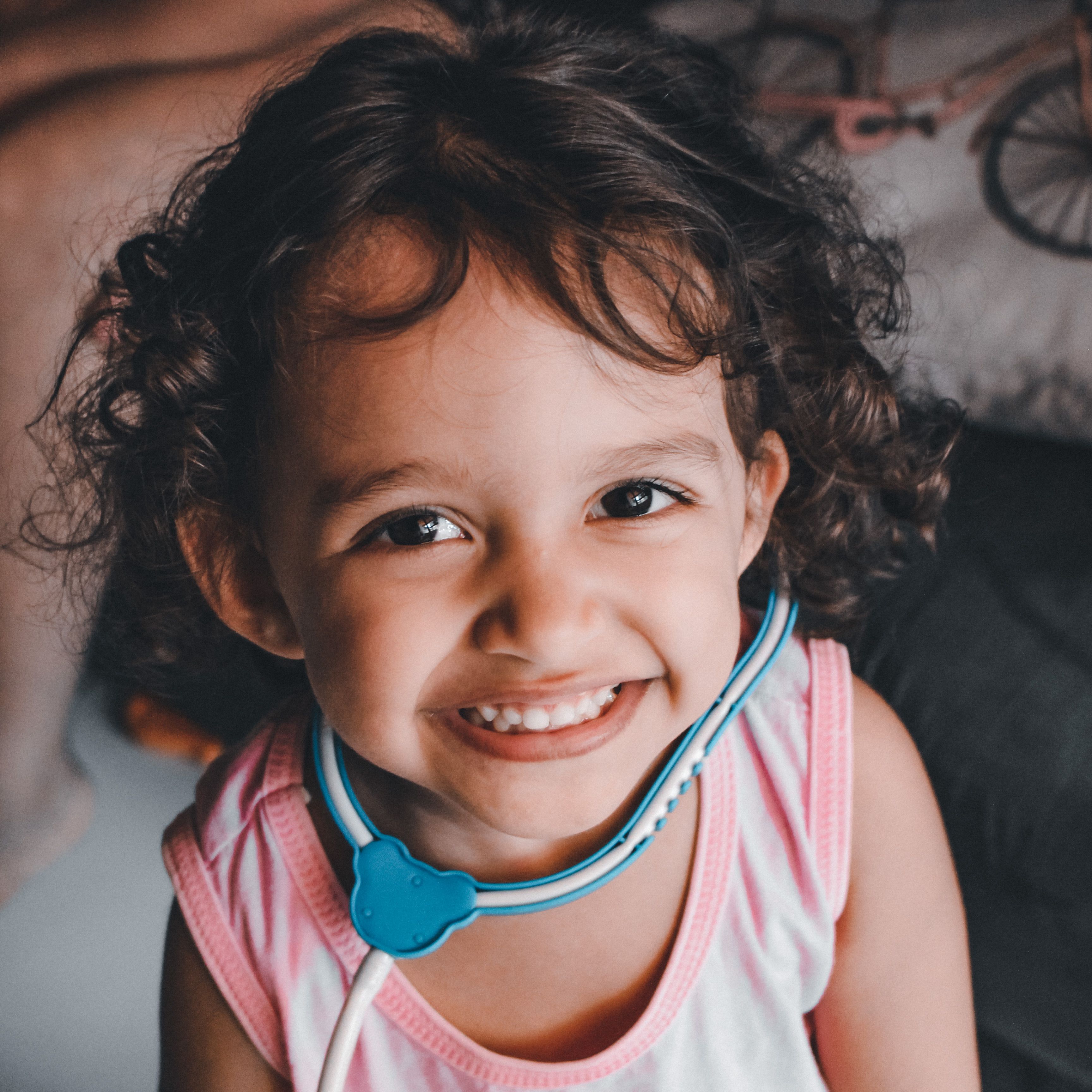 A Pretty Girl in Pink Tank Top with a Toy Stethoscope