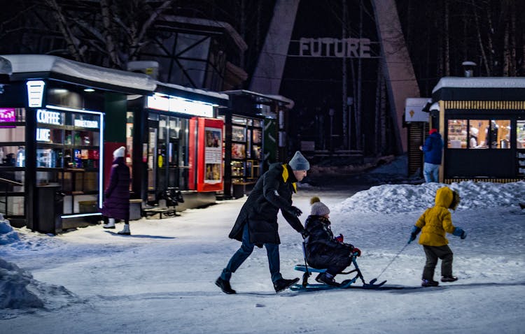 A Family Playing On The Snow