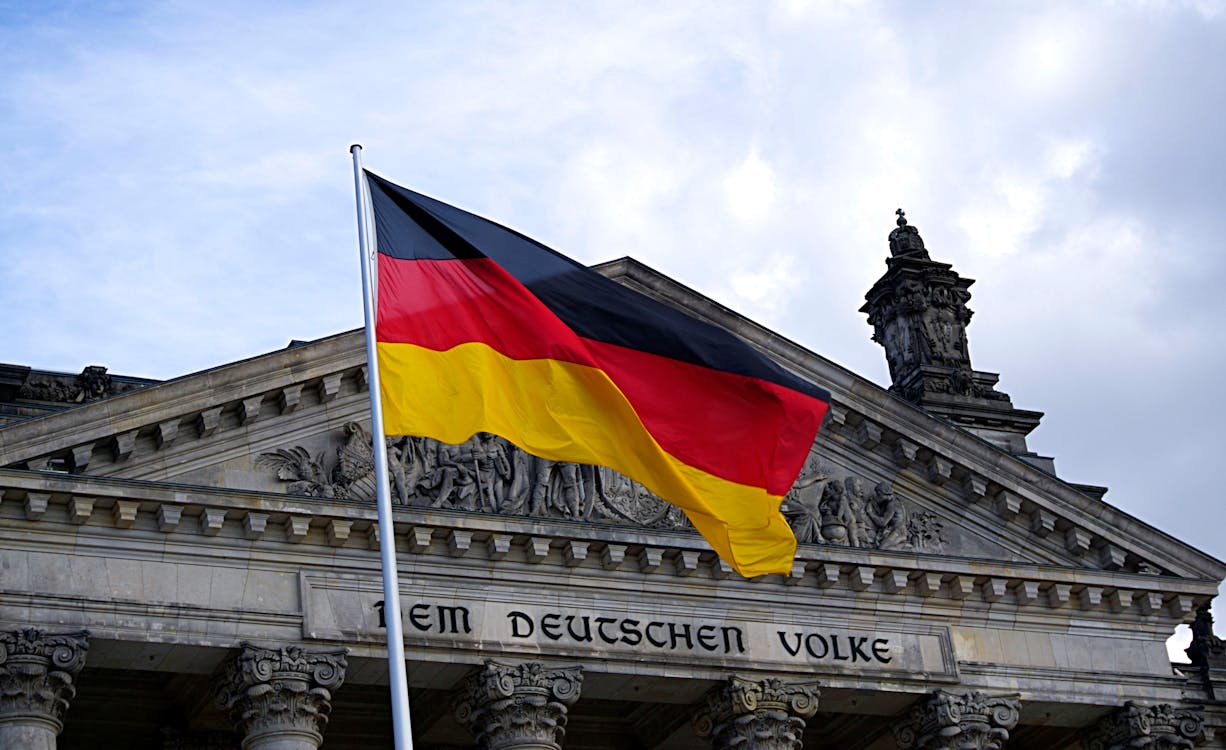  A German flag in front of a building.