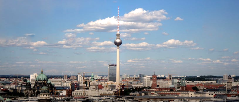 Panoramic view of Berlin's skyline with Fernsehturm TV tower under a clear blue sky. by Ingo Joseph