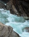 Waterfalls Between Brown Rocky Mountain