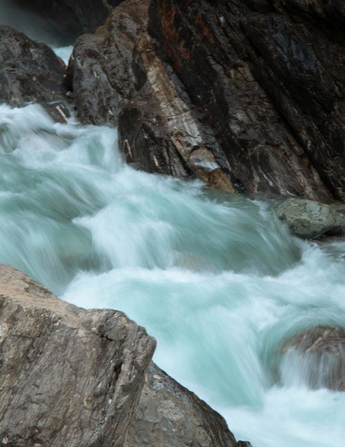 Free Captivating waterfall over rugged rocks showcasing natural beauty and motion. Stock Photo