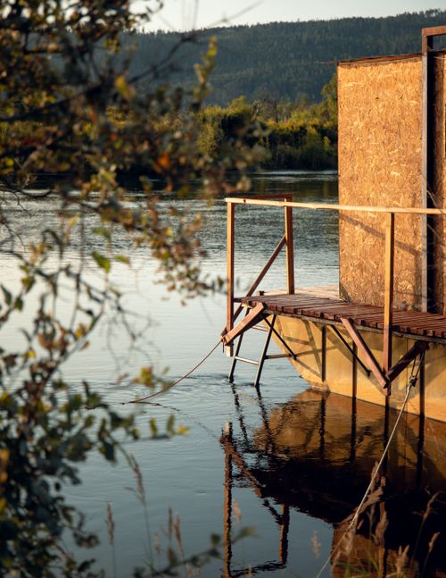 Free Peaceful wooden dock on a calm lake during sunset, surrounded by nature. Stock Photo