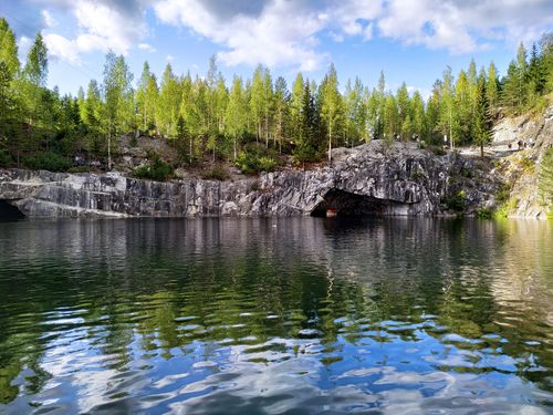 Free Beautiful lake reflecting trees and rocks in Marble Canyon, Karelia, on a sunny day. Stock Photo