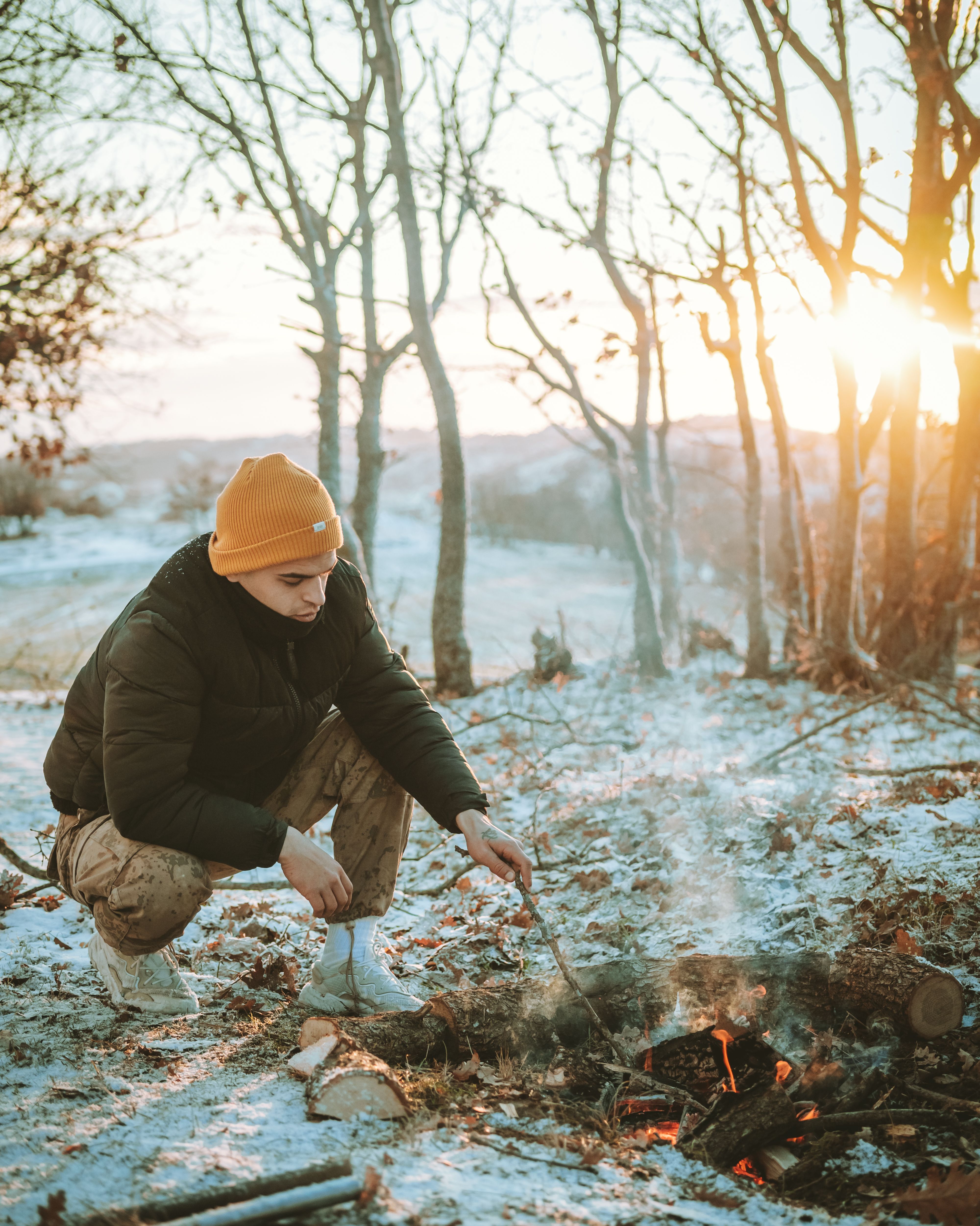 A Man Sitting Beside the Campfire · Free Stock Photo