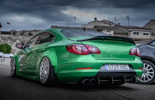 Free A sleek green custom sedan parked on a street in Alcoletge, Spain, showcasing automotive design. Stock Photo