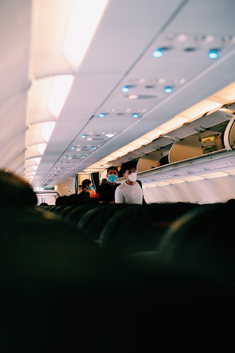 People Walking At The Airplane Aisle 