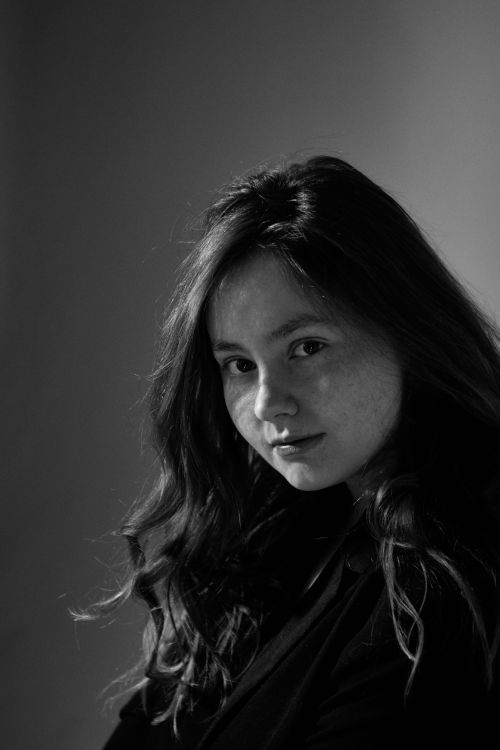Free Artistic monochrome portrait of a young woman with dramatic lighting. Stock Photo