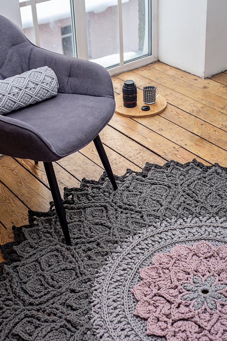 A Gray Padded Chair On A Gray Rug