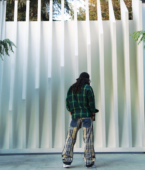 Back View of a Person Wearing a Plaid Long Sleeve Shirt and Pants