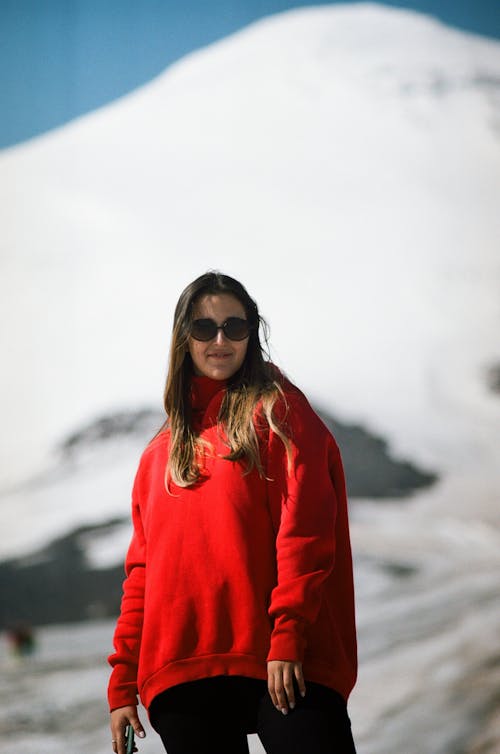 A Woman in a Red Sweater Wearing Black Sunglasses