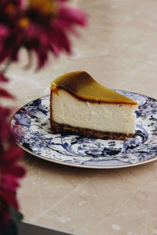 Close-Up Shot of a Slice of Cheesecake on a Plate