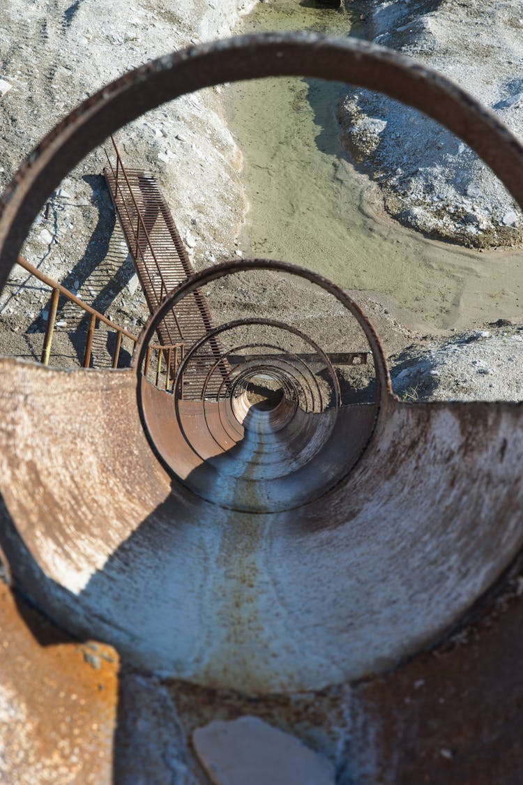 A Top View Of A Brown Round Rusty Steel Down Spout