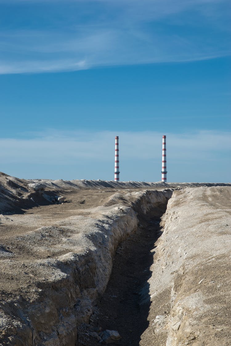 Factory Chimneys Under The Blue Sky