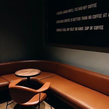 Warm and inviting coffee shop corner in Istanbul featuring stylish furniture and unique wall text.