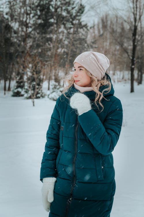 A Woman in Teal Winter Jacket Standing 