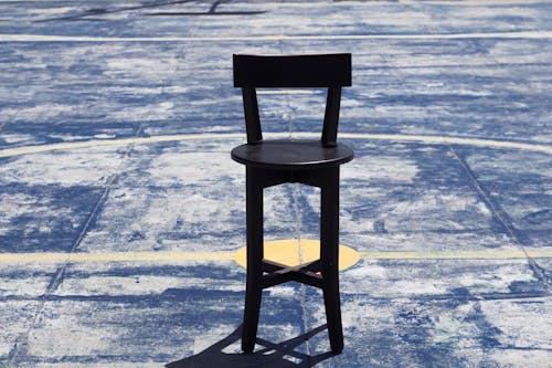 Free A Black Wooden Chair on the Court Stock Photo