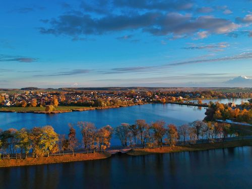 Free Explore the stunning autumn hues and tranquil waters of Niasviž Lake in Belarus from above. Stock Photo
