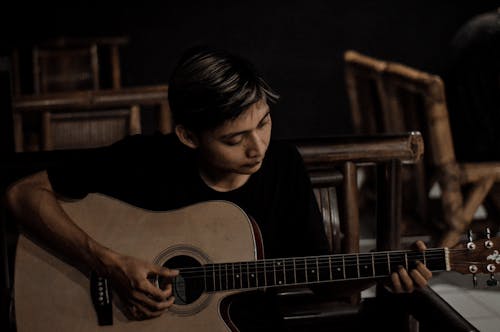Free A Man Playing an Acoustic Guitar Stock Photo