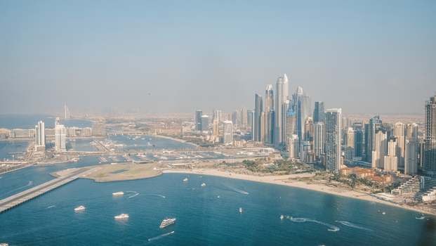 Stunning aerial photography of Dubai Marina's towering skyscrapers and waterfront during the day.