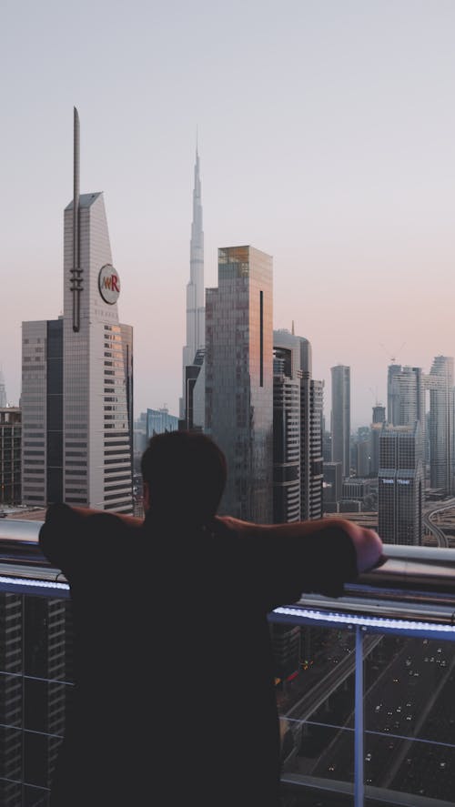 Free A Man Looking at the City Buildings Stock Photo