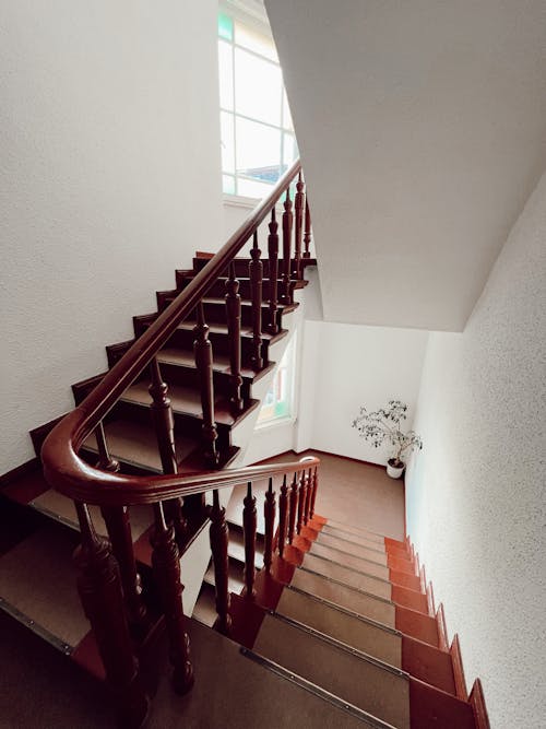 A Brown Wooden Staircase and White Painted Wall
