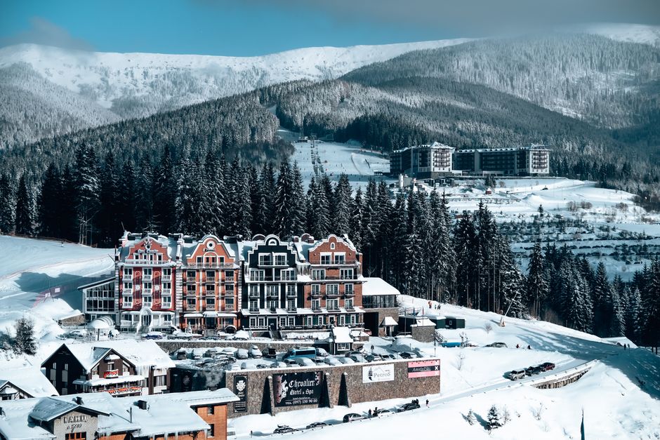 Aerial view of a picturesque ski resort nestled in snow-covered mountains, ideal for winter sports enthusiasts.