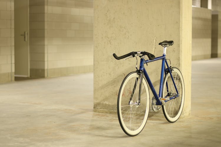 A Blue Bicycle With Black Handlebars 