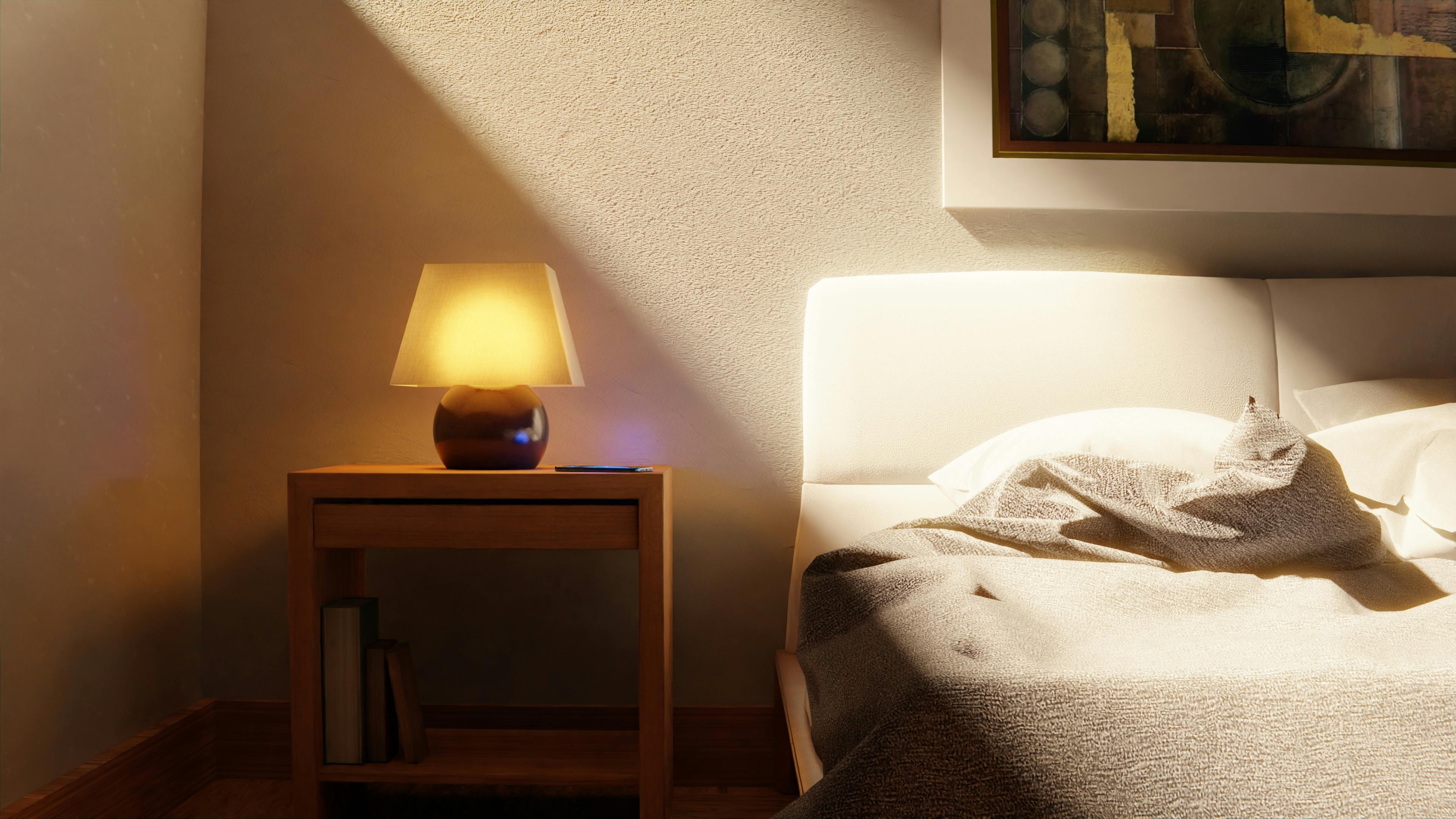 Warm and inviting bedroom interior with a bedside lamp and abstract art.