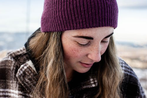 Close-Up Shot of a Woman in Purple Knitted Cap