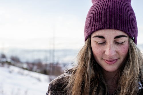 Woman in Brown and White Jacket Wearing Purple Beanie Hat