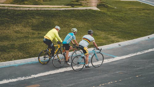 Free People Riding a Bicycle while Wearing Helmets Stock Photo