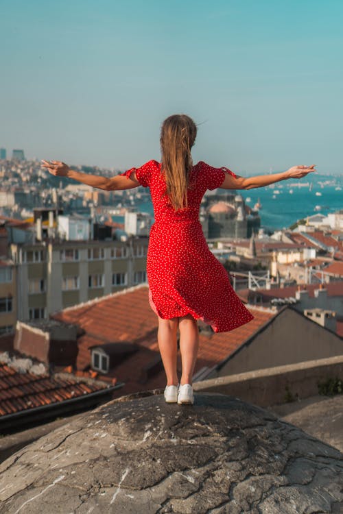 Woman in Red Dress Standing on Concrete