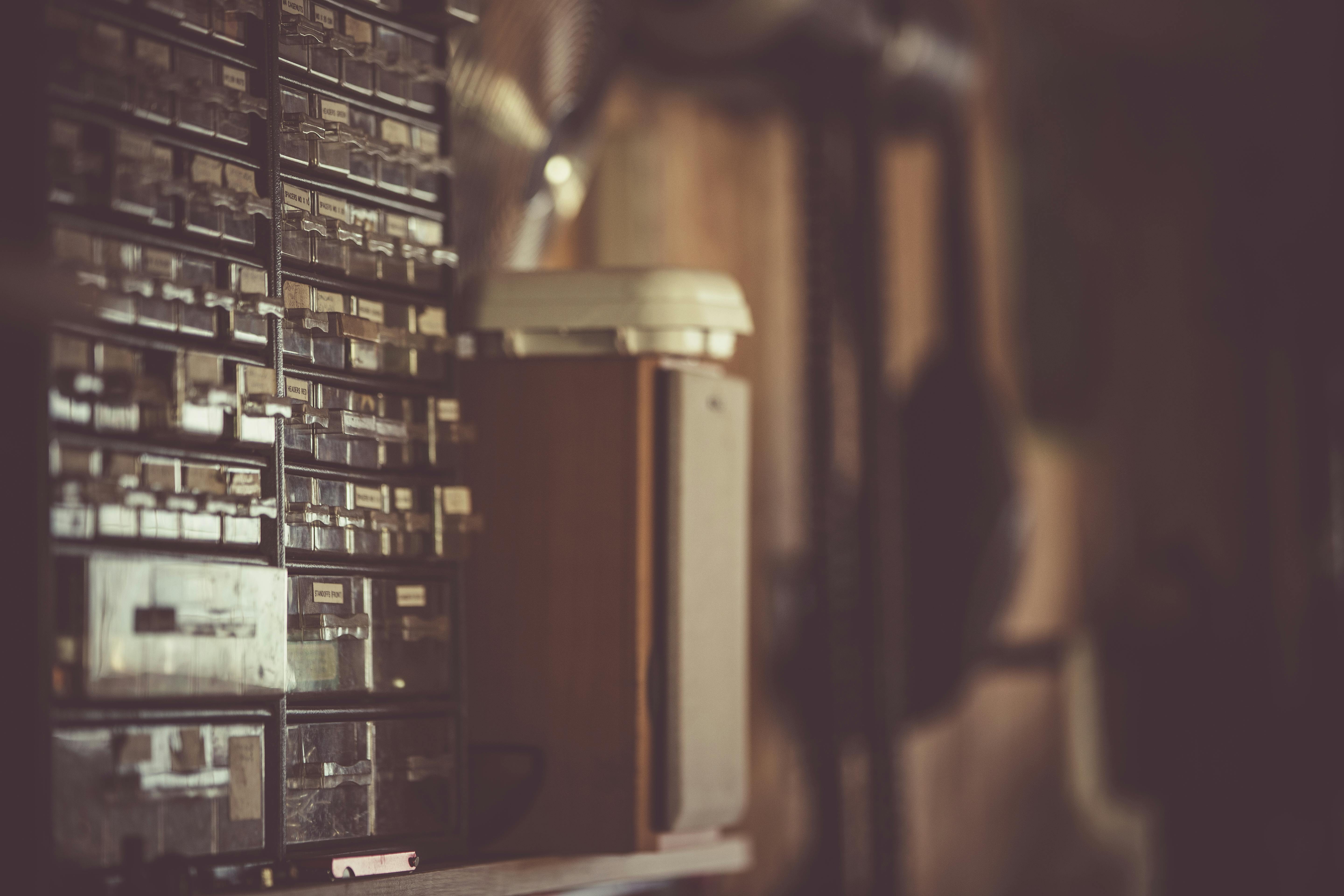 复古储物柜的抽屉贴有标签，在昏暗的光线下，营造出怀旧氛围