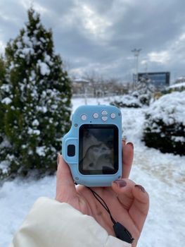 A winter scene in Istanbul with snow-covered ground and camera in hand, capturing nature.