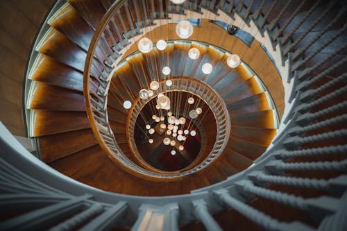 Free Brown Wooden Spiral Staircase With Glass Chandelier Stock Photo