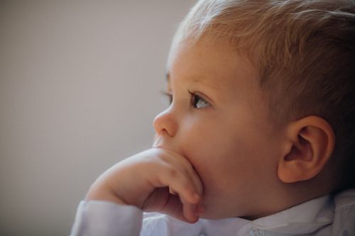 Free Close-up portrait of a thoughtful child gazing into the distance, showcasing innocence and curiosity. Stock Photo