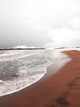 Calm seascape with waves and sandy shoreline in Ordu, Turkey.