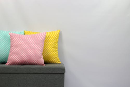 Free Pink and White Throw Pillow on Brown Couch Stock Photo