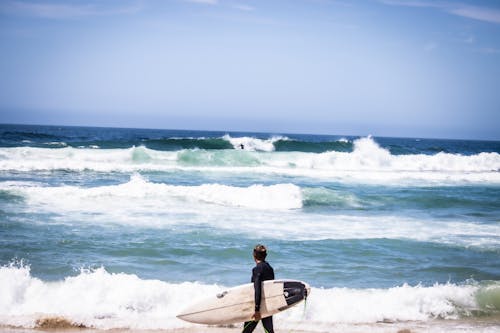 A Man Holding a Surfboard