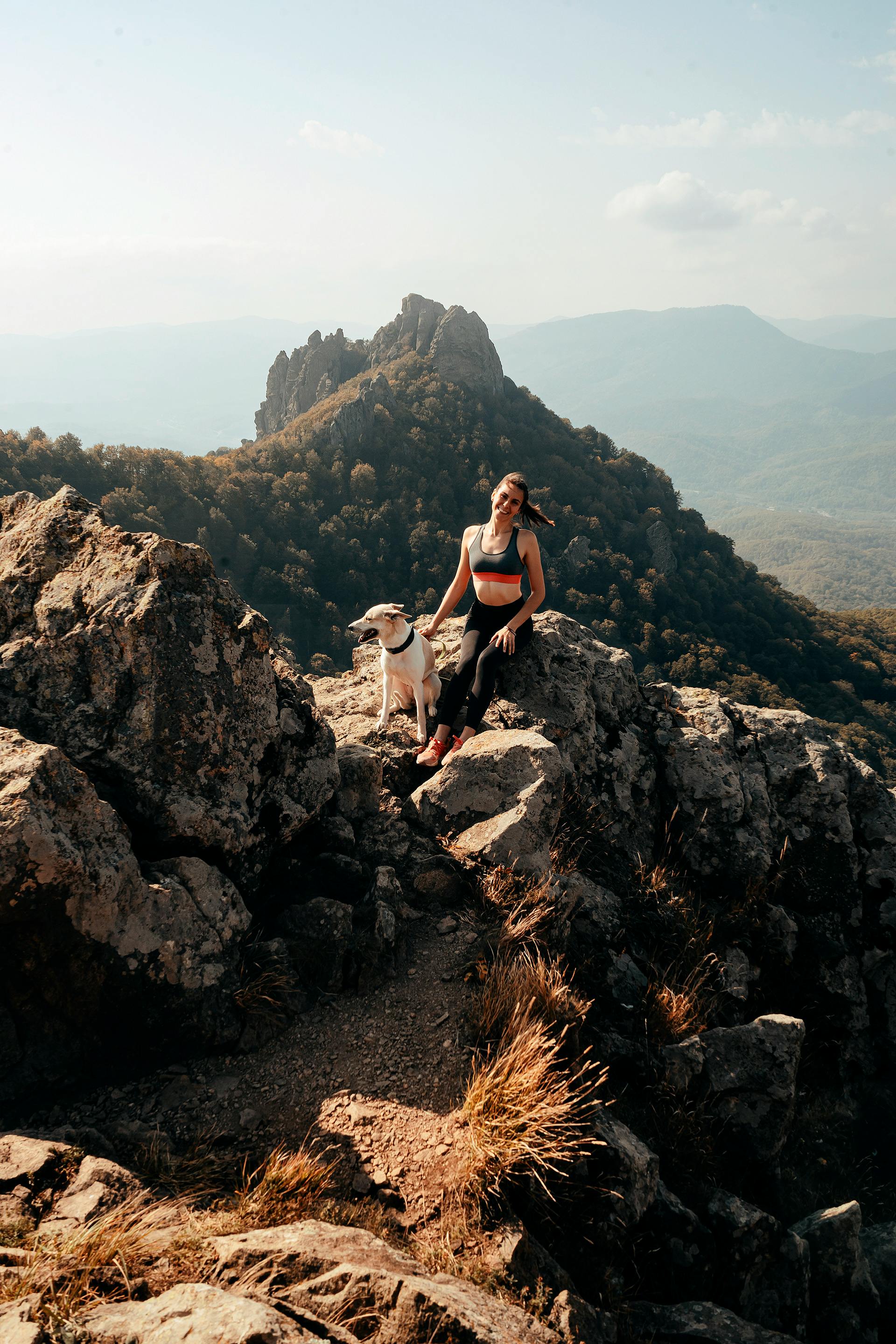 woman with dog in mountains