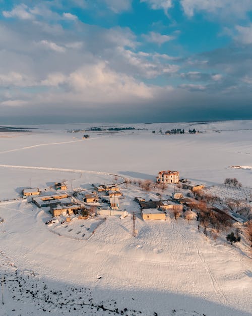 White and Brown Houses on Snow-Covered Field