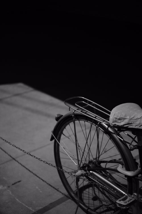 Free Artistic grayscale photo of a bicycle wheel casting a shadow, adding a classic touch. Stock Photo